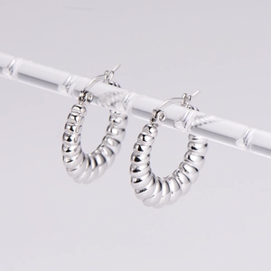 Pair of silver stainless steel croissant hoop earrings with a vintage twisted design