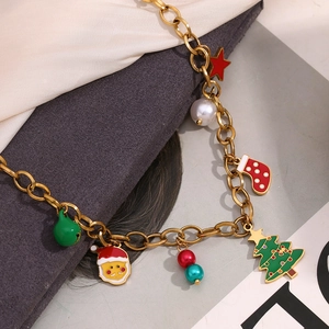 Detail of 18K gold-plated necklace featuring enamel Christmas tree and Santa pendants