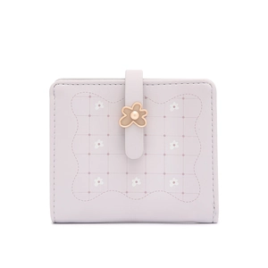 Detail view of purple mini wallet with floral print, lattice pattern and gold flower buckle