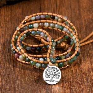 Detailed view of woven leather bracelet with Indian agate beads and Tree of Life charm