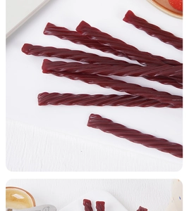 Detailed macro view of spiral textured dark red licorice twists in a tea time setting