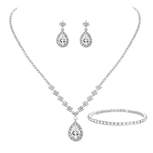 Macro detail of silver-toned jewelry set featuring pear-cut cubic zirconia drop accents