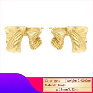 Vintage gold brushed striped bow stud earrings made of textured brass for women