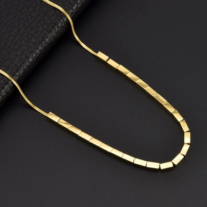 Minimalist gold snake chain necklace with rectangular pendants on black leather background