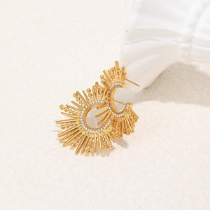 Detailed view of 18K gold plated C-shaped earrings with sparkling cubic zirconia inlay