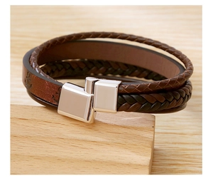 Detailed close-up of multilayer braided leather bracelet with stainless steel magnetic clasp