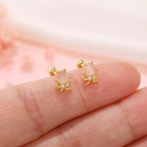 Macro shot of octopus stud earring with pink cat eye stone and white zircon details