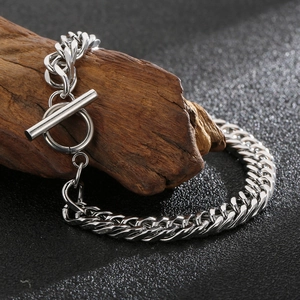 Silver cuban link chain bracelet with toggle clasp displayed on vintage wood backdrop