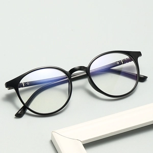 Detailed side view of classic black round glasses frame with metallic hinge hardware
