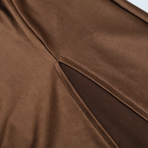 Close-up of side slit stitching on brown satin backless slim-fit party evening gown