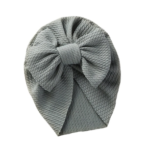 Dusty blue infant turban hat with a large bow detail and ribbed knit texture