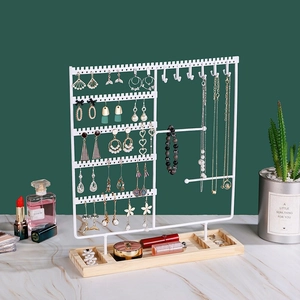 White metal jewelry display stand with multi-tier earring rack and wooden base tray