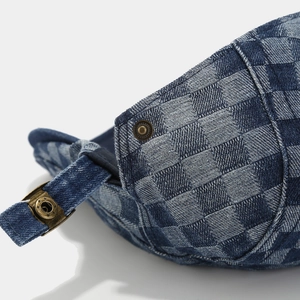 Detail of blue denim checkerboard beret with vintage bronze metal adjustable buckle