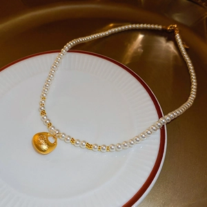 Elegant Chinese New Year pearl necklace featuring a golden Fu lucky bag pendant for women