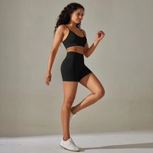 Close-up of black ribbed seamless yoga set showing high-waisted shorts and U-neck bra
