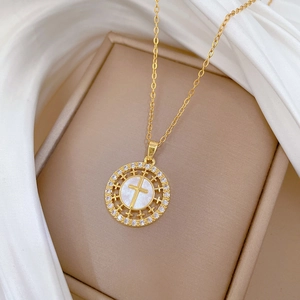 Elegant gold titanium steel cross necklace with shell inlay and zircons in a jewelry box