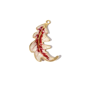 Close-up of feather-shaped titanium steel pendant with white and red enamel detailing