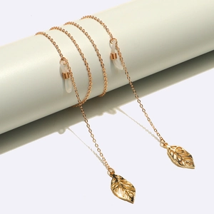 Close-up of golden metal eyeglass chain featuring hollow leaf pendant and anti-slip loop