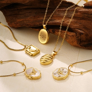Vintage 18K gold stainless steel lockets with celestial pendants and mixed chain styles