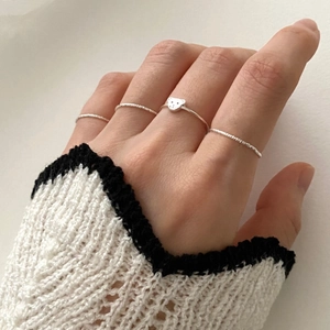 Detailed view of four piece silver bear ring set with twisted rope texture on model hand