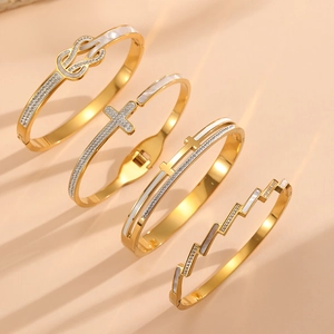 Detail of four 18K gold plated bangles with shell inlays and diamond accents set