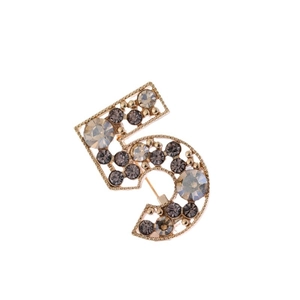 Elegant gold-tone number 5 brooch with dark grey and clear rhinestones on white background