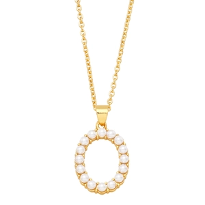 Macro detail of golden oval pendant with delicate inlaid white pearls on the edge