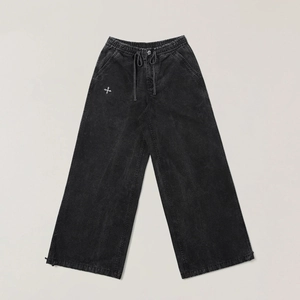 Faded black cargo pants with washed finish and wide leg cut in a flat lay view