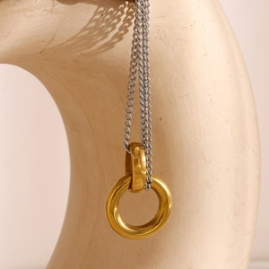 Detailed view of dual-tone 18K gold double ring pendant on fine silver chain necklace