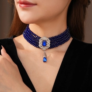 Close-up of vintage blue beaded multi-layer choker necklace with luxury stone pendant