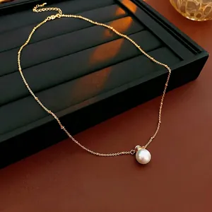 Elegant gold beaded chain necklace featuring a luminous large white artificial pearl pendant