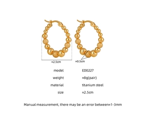 Macro view of titanium steel hoop earrings with alternating matte and polished gold beads