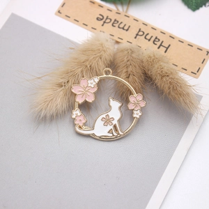 Golden alloy pendant featuring a white cat silhouette and pink cherry blossoms on gray card
