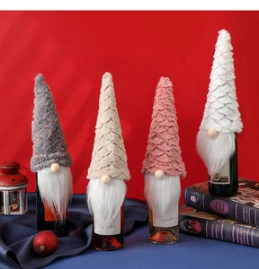 Close-up of plush gnome wine bottle covers in assorted colors with festive decor