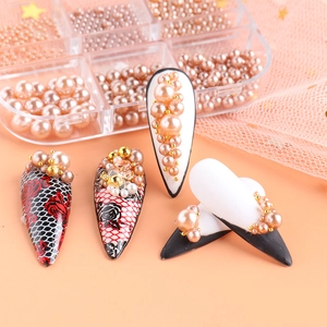 Macro view of nail art tips with pearls, golden beads and rose grid pattern designs