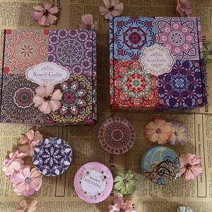 Flat lay of mandala pattern scented candles with happy wedding gift box on retro paper