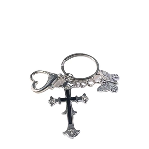 Retro gothic cross and butterfly metal keychain with silver finish and black enamel