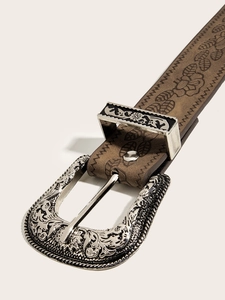 Detail of vintage brown leather belt with floral embossing and engraved silver buckle