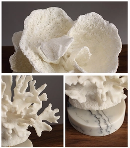 Detailed view of Nordic faux resin coral decor with natural porous texture and marble base