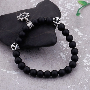 Nautical beaded bracelet with silver anchor and helm charms on matte black stones