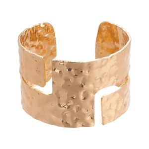 Irregular hammered gold cuff bracelet with geometric texture and minimalist open design
