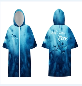 Detail of hooded surf poncho with gradient sea blue colors and manta ray print