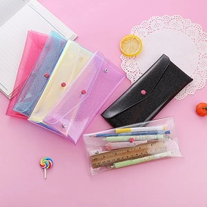 Detail view of colorful glitter PVC stationery pouches with secure snap button closure