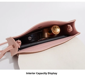 Interior storage capacity of pink mini crossbody bag with phone, lipstick and cushion