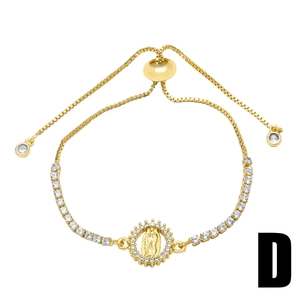 Macro detail of gold-plated Virgin Mary pendant with sparkling cubic zirconia on box chain