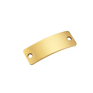 Close-up of a polished gold curved rectangular metal tag with two holes for DIY jewelry