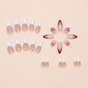 Detailed view of long almond press-on nails with 3D floral relief and pearl accents
