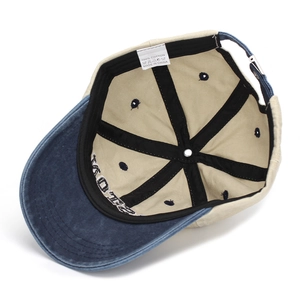 Detail view of cotton baseball cap interior featuring metal buckle and embroidery