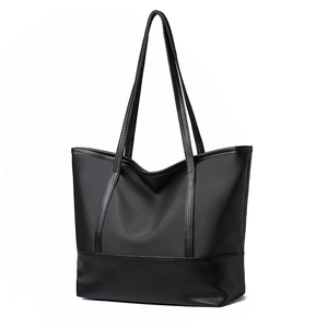 Minimalist black oxford fabric tote bag with leather straps for daily commute use