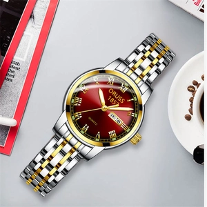 Detail of ORUSS business watch with burgundy dial and gold Roman numerals indices